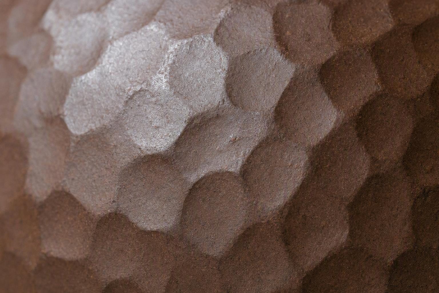 A close view of the surface decoration and clay finish