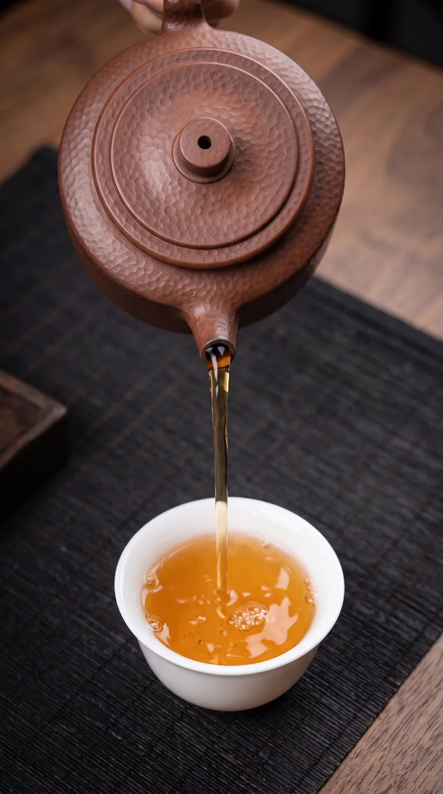 Hammered Earth: tea moving from the hand-worked spout