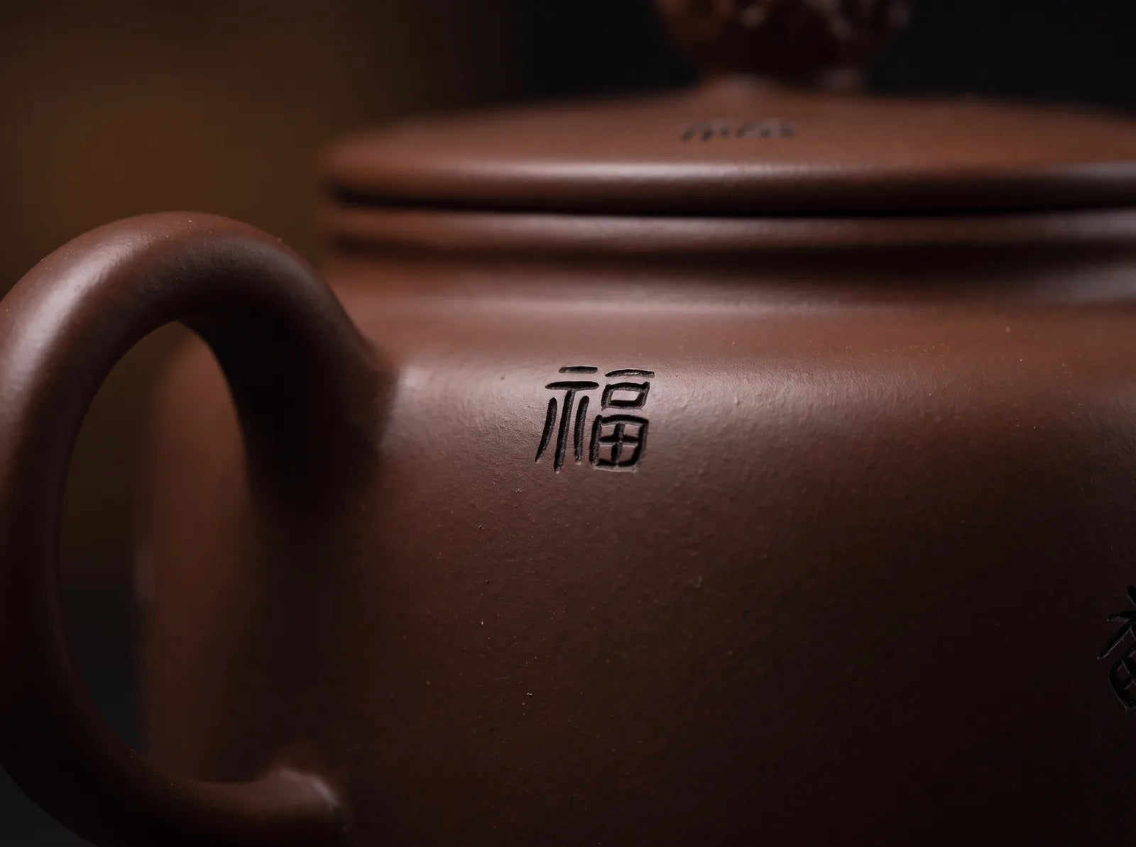 A close view of the surface decoration and clay finish