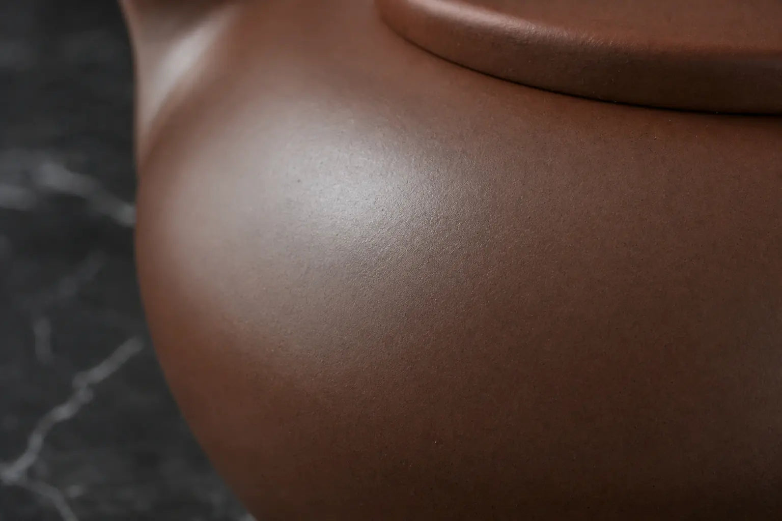 A close view of the surface decoration and clay finish
